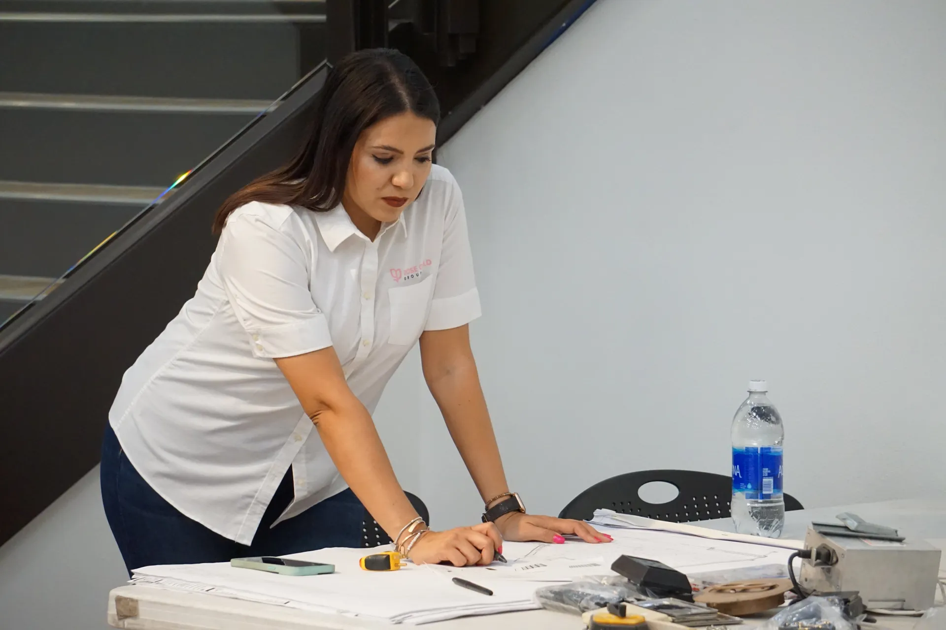 Rose Gold Group founder Nayeli Meza reviewing ADU construction plans