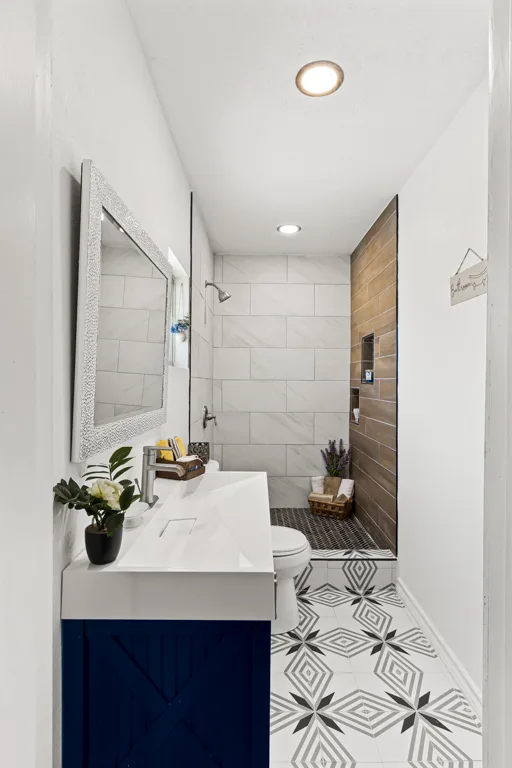 Designer bathroom with patterned tile floor, Rose Gold Group interior design